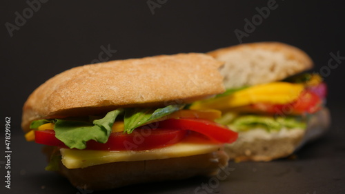 Delicious sandwich on a black background.