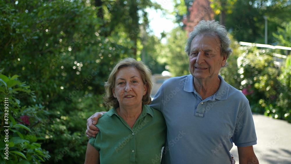 older couple walking together, senior people relationship outside in day walk