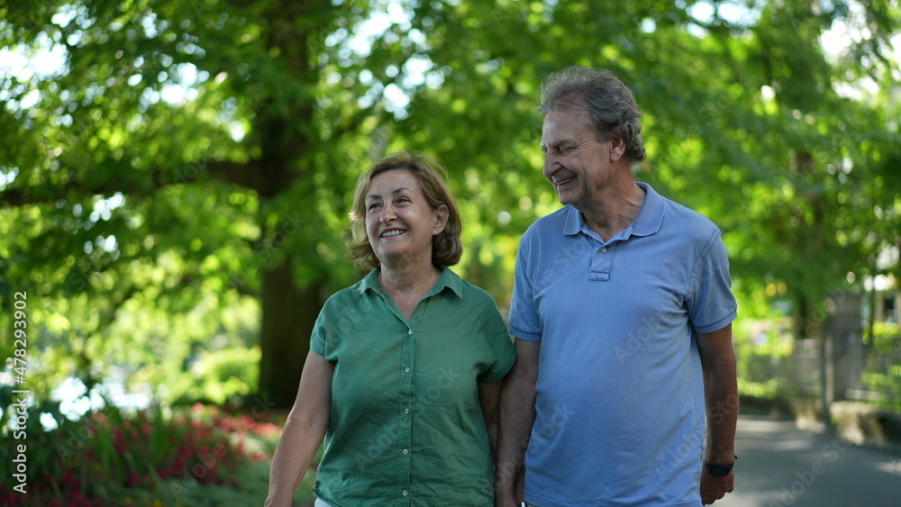 Happy senior couple walking together in afternoon walk Happy senior couple walking together in afternoon walk