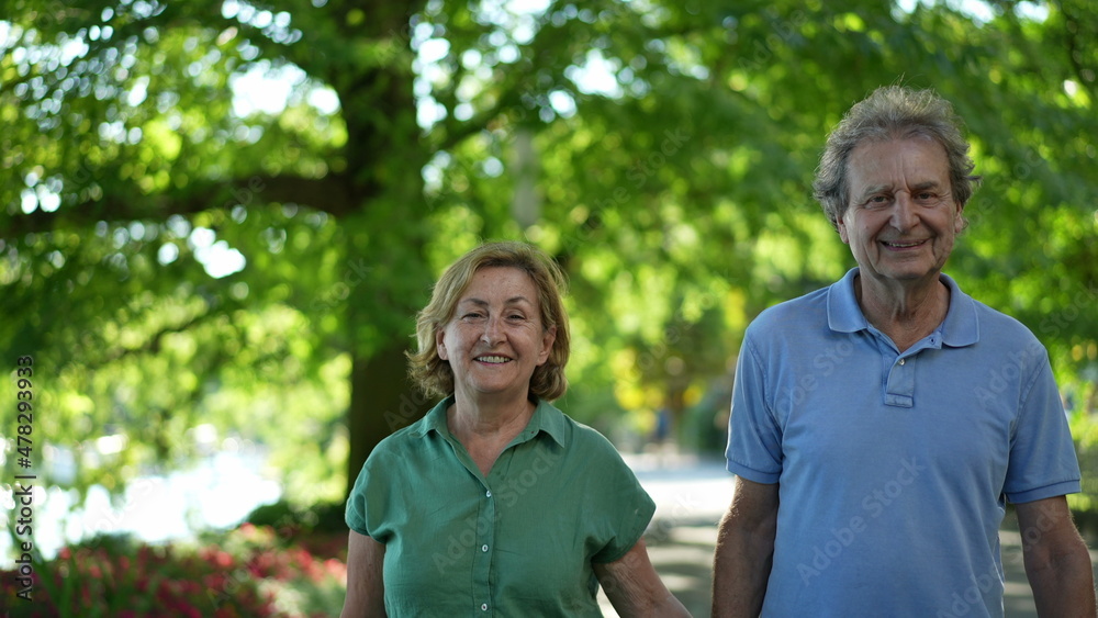 Happy senior couple walking together in afternoon walk Happy senior couple walking together in afternoon walk