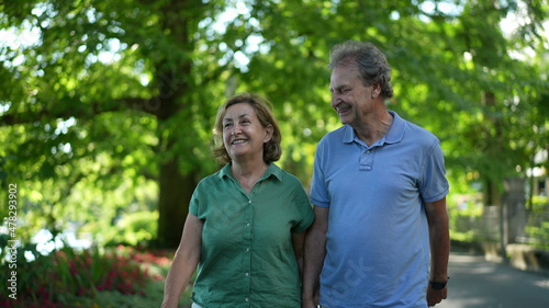 Happy senior couple walking together in afternoon walk © Marco