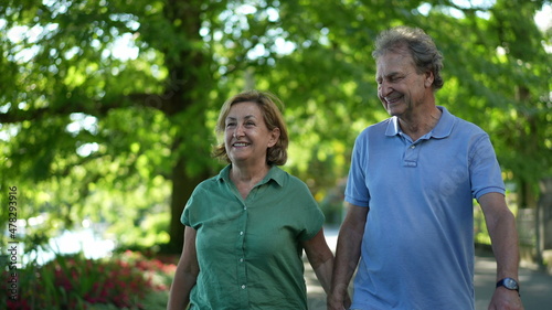 Happy senior couple walking together in afternoon walk