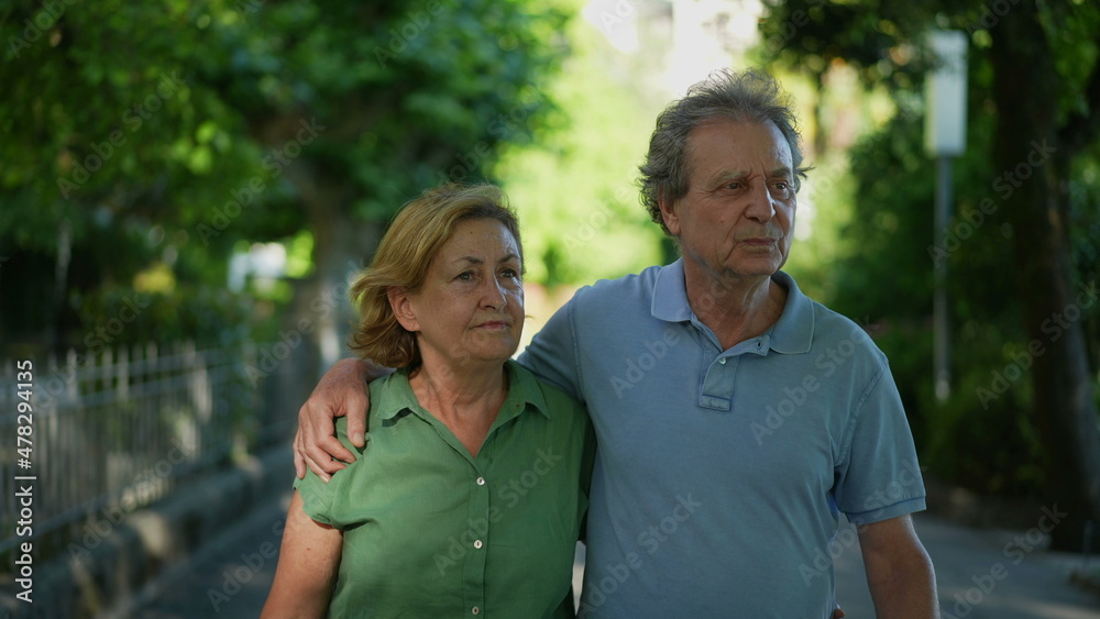 Happy senior couple walking together in afternoon walk Happy senior couple walking together in afternoon walk