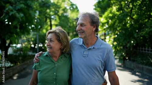 Happy senior couple walking together in afternoon walk