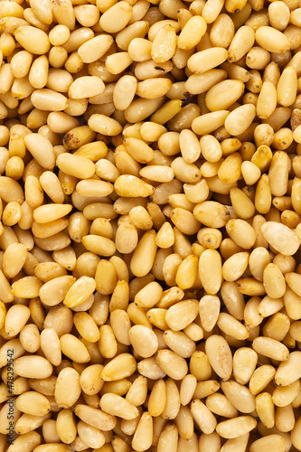 Peeled golden pine nuts top view from siberia