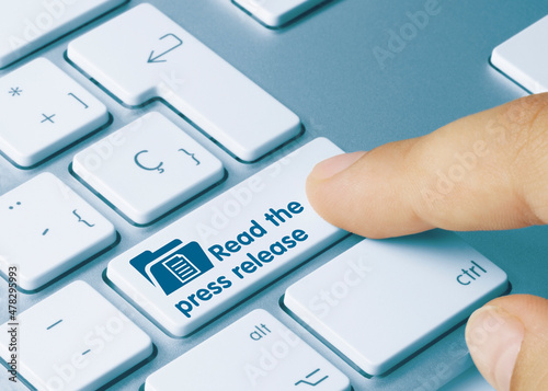 Fotografía Read the press release - Inscription on Blue Keyboard Key.