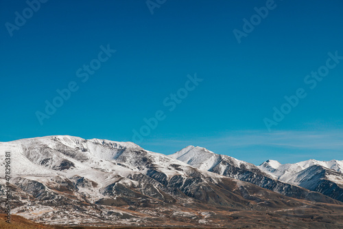 High cliffs in the mountains with snow on the peaks in Altai