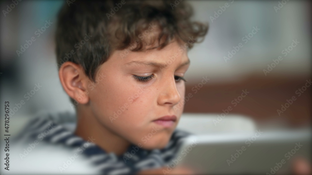 Child surprised reaction holding tablet. Boy WOW face emotion Child surprised reaction holding tablet. Boy WOW face emotion