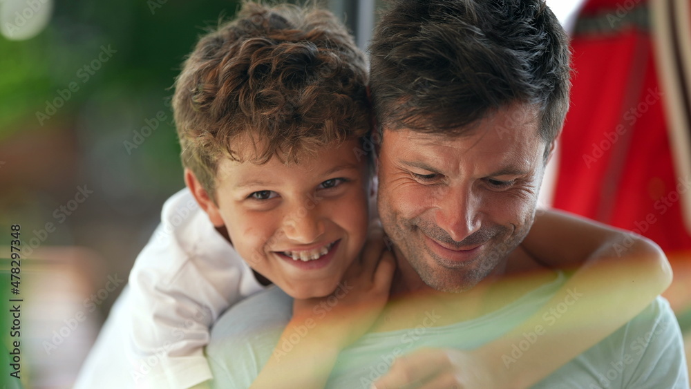Child kissing father on the cheek, candid and real life family love and affection Child kissing father on the cheek, candid and real life family love and affection