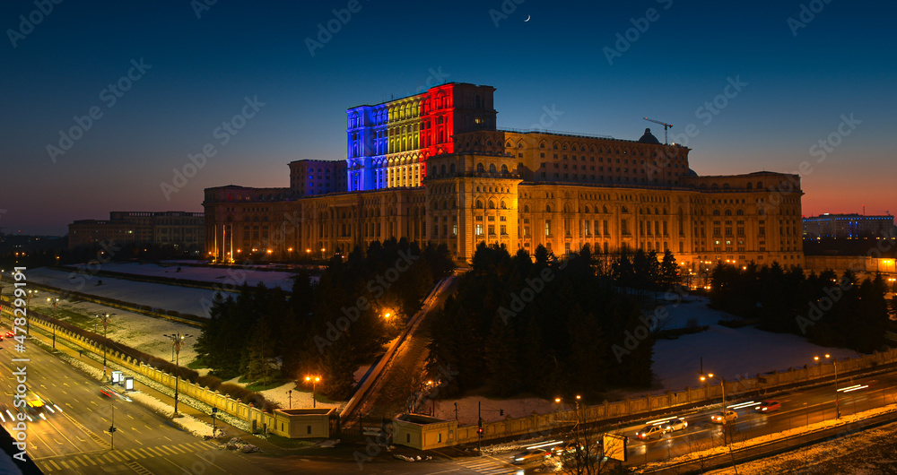Obraz na płótnie Palace of the Parliament building in Bucharest with the national flag of Romania projected on it w salonie
