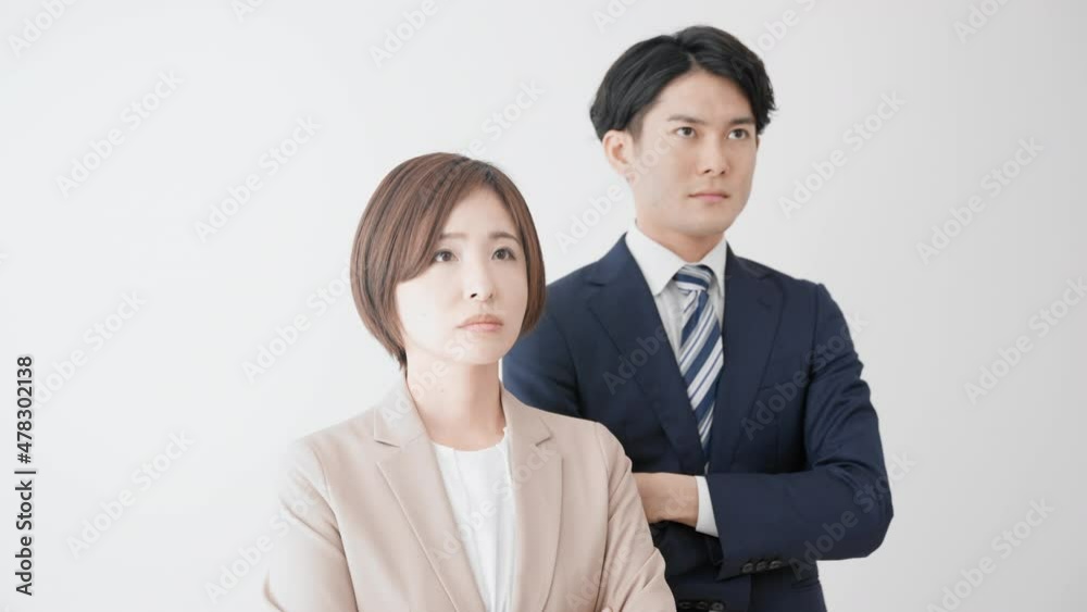 腕組みをして立つビジネスマンとビジネスウーマン 腕組みをして立つビジネスマンとビジネスウーマン