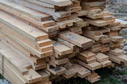 Close up photo of stack Of wooden planks on a storage