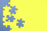 Unfinished puzzle on a yellow background, business concept, goal achievement