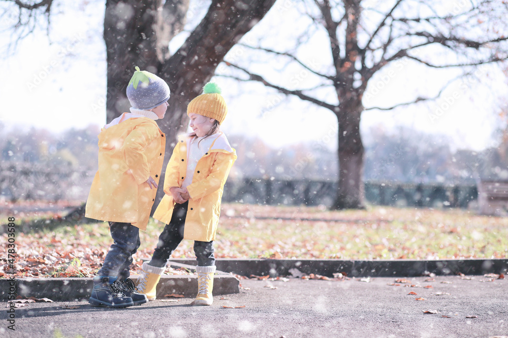 Kids walk in the park first snow Kids walk in the park first snow