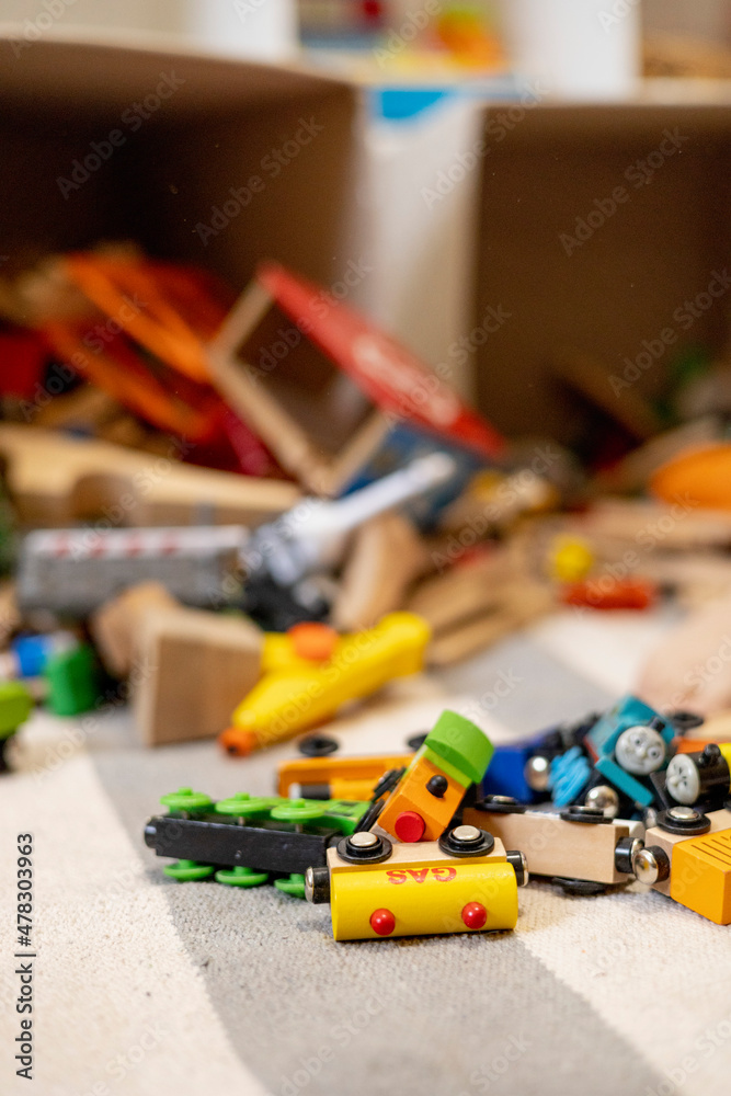 Toys are scattered around the room. Wooden rails and a steam locomotive. Defocus. Toys are scattered around the room. Wooden rails and a steam locomotive. Defocus.
