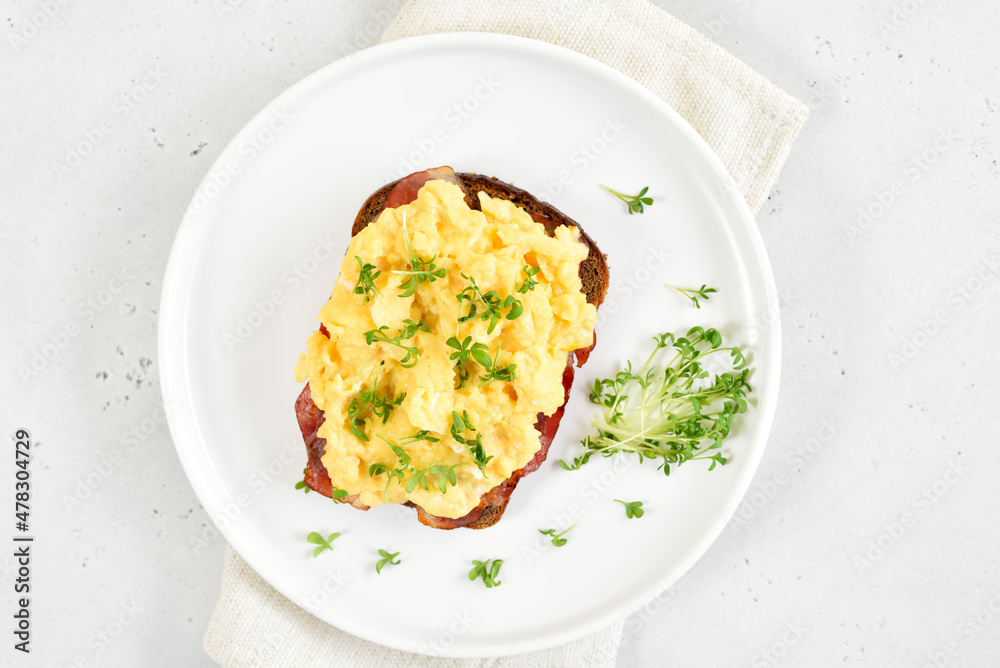Scrambled eggs with microgreen on bread. Scrambled eggs with microgreen on bread.