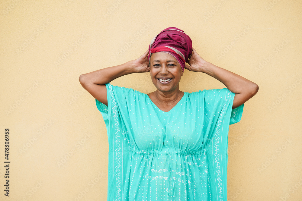 Happy senior african woman looking at camera - Focus on face Happy senior african woman looking at camera - Focus on face