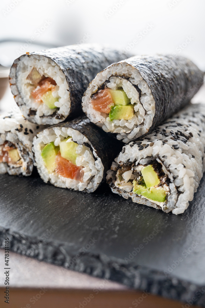 Sushi rolls. Homemade rolls with salmon, avocado and cucumber. Sushi rolls. Homemade rolls with salmon, avocado and cucumber.