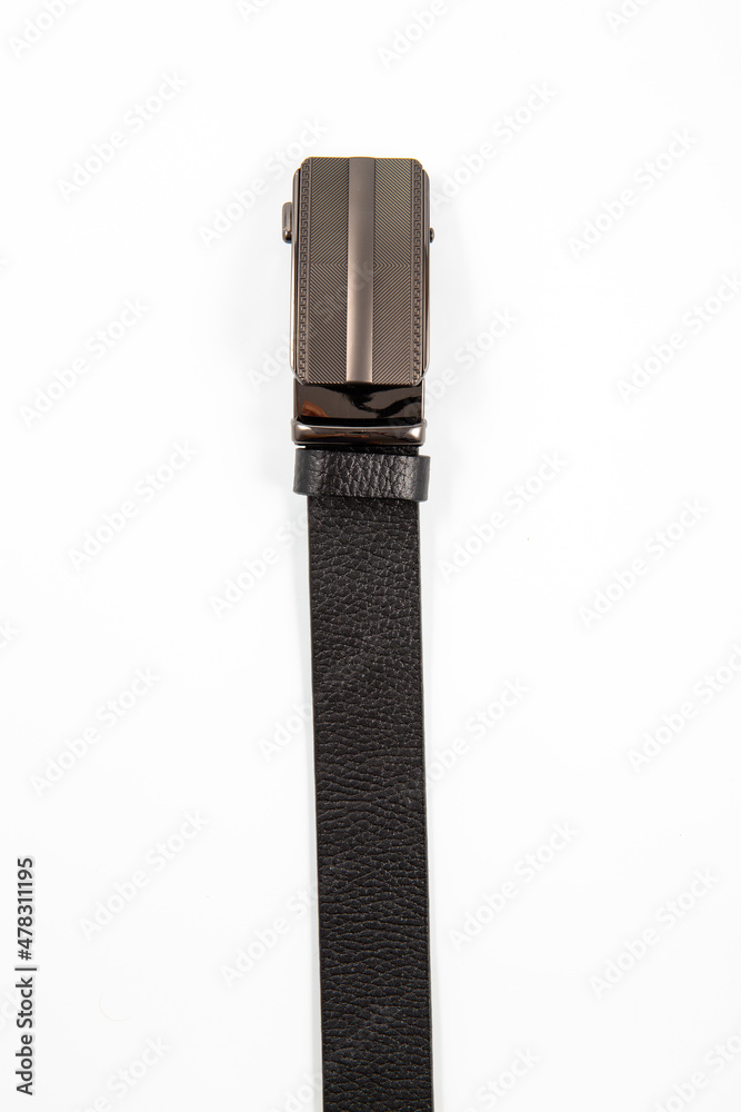 Fastened fashionable men's leather belt with dark matted metal buckle isolated on white background. Fastened fashionable men's leather belt with dark matted metal buckle isolated on white background.
