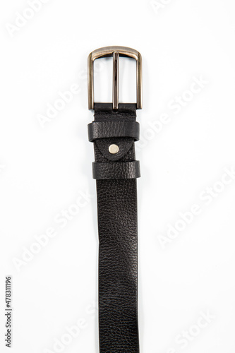 Fastened fashionable men's leather belt with dark matted metal buckle isolated on white background.