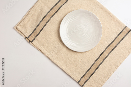 Empty plate on withe background table and napkin. Food background for menu, recipe. Flat Lay, top view for Table setting. Mockup for restaurant dish. 