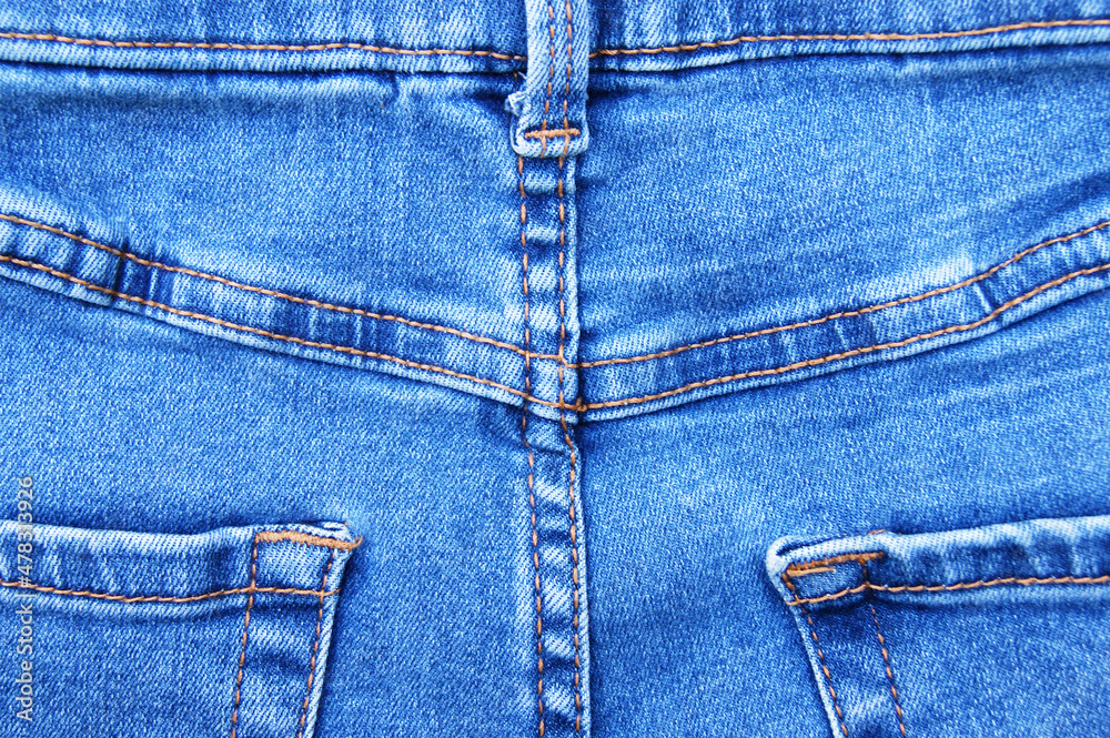 Flat lay, denim jeans leg seam detail, background texture. Flat lay, denim jeans leg seam detail, background texture.
