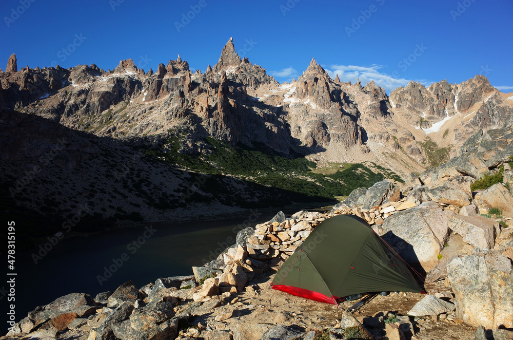 Camping tent among stones with impressive mountain landscape view, Nahuel Huapi National Park steep granite rock formations Torre Principal peak of Cerro Catedral, Nature of Patagonia, Argentina