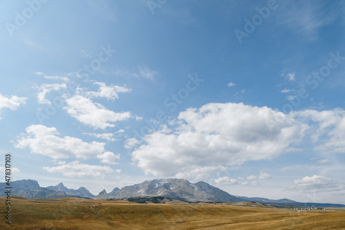 High mountain range over a valley against a blue sky in Durmitor National Park