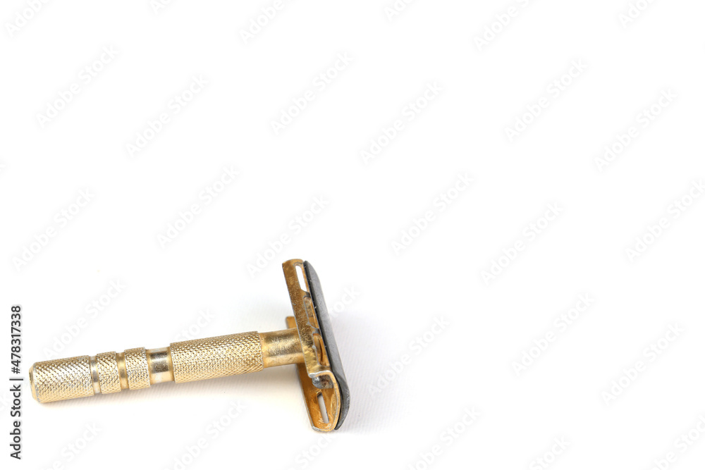 Steel gold razor on white background, copy space Steel gold razor on white background, copy space