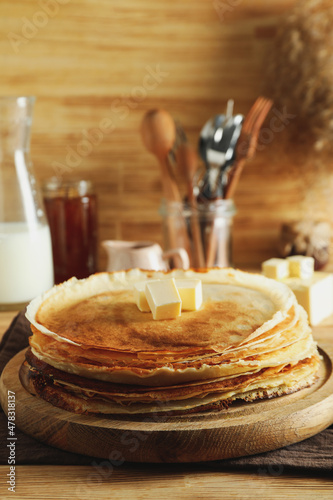 Concept of cooking with crepes on wooden table