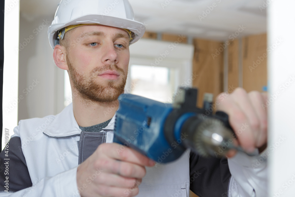 man drilling the wall with drill perforator man drilling the wall with drill perforator