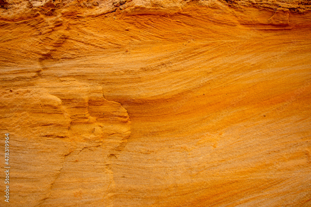 Textural sand, with relief surface, multi-colored layers and different in size of granules, in outdoor sand career, after mining ore and sand for construction. Textural sand, with relief surface, multi-colored layers and different in size of granules, in outdoor sand career, after mining ore and sand for construction.