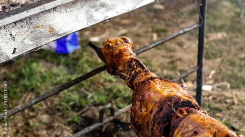 Whole sheep roasting on a spit