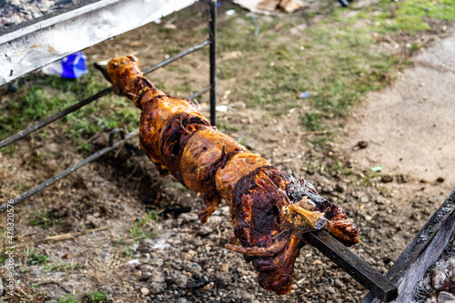 Whole sheep roasting on a spit