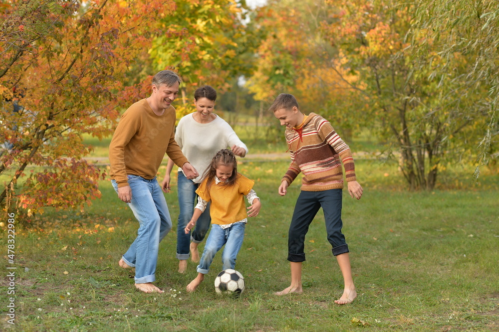 Fototapeta premium Portrait of big happy family playing football in park