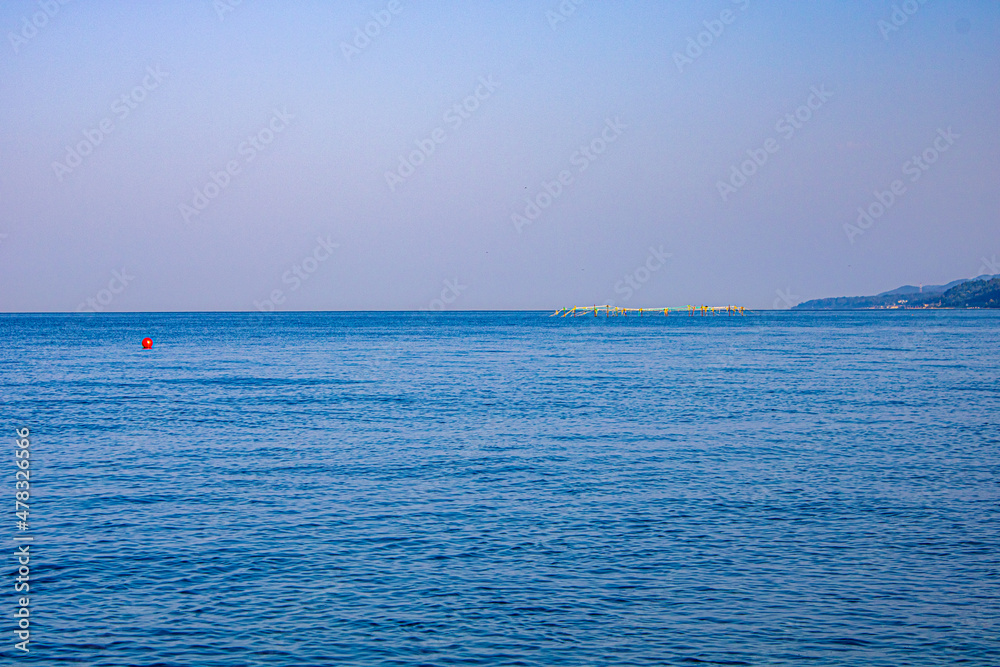 A hot sunny day with the purest sea water on the Black Sea coast in Pitsunda Abkhazia. Nice seascape.