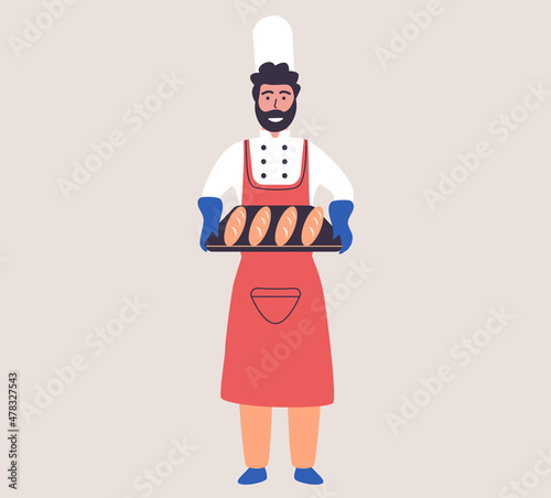 Family bakery concept with happy man baker holding tray of baguettes. Dough maker with bread and cooking tools. Happy male cook in apron and hat, pastry-cook in uniform working in family bakery