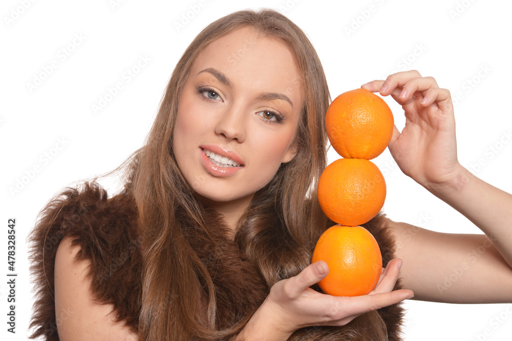 Portrait of young woman posing with oranges Portrait of young woman posing with oranges
