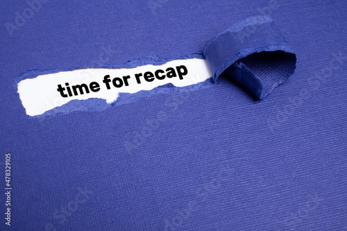 The text TIME FOR RECAP appearing on whitepaper behind torn blue paper.