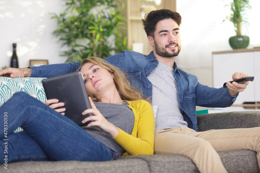 happy couple is relaxing and playing together the living room happy couple is relaxing and playing together the living room