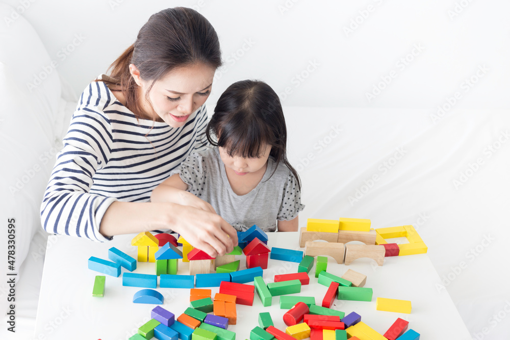 asian baby and her mother play puzzle wood toy, leaning and development asian baby and her mother play puzzle wood toy, leaning and development