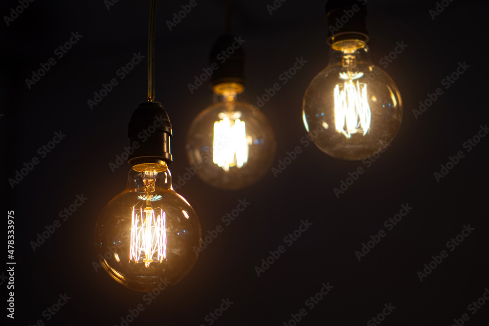 incandescent light bulb on dark background