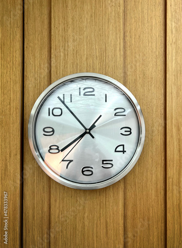 Classic wall clock on wooden background