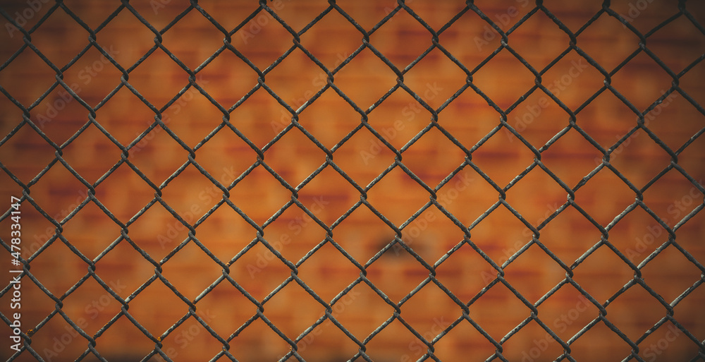 A fence made of a metal mesh close-up. Abstract background. Grunge background. A fence made of a metal mesh close-up. Abstract background. Grunge background.