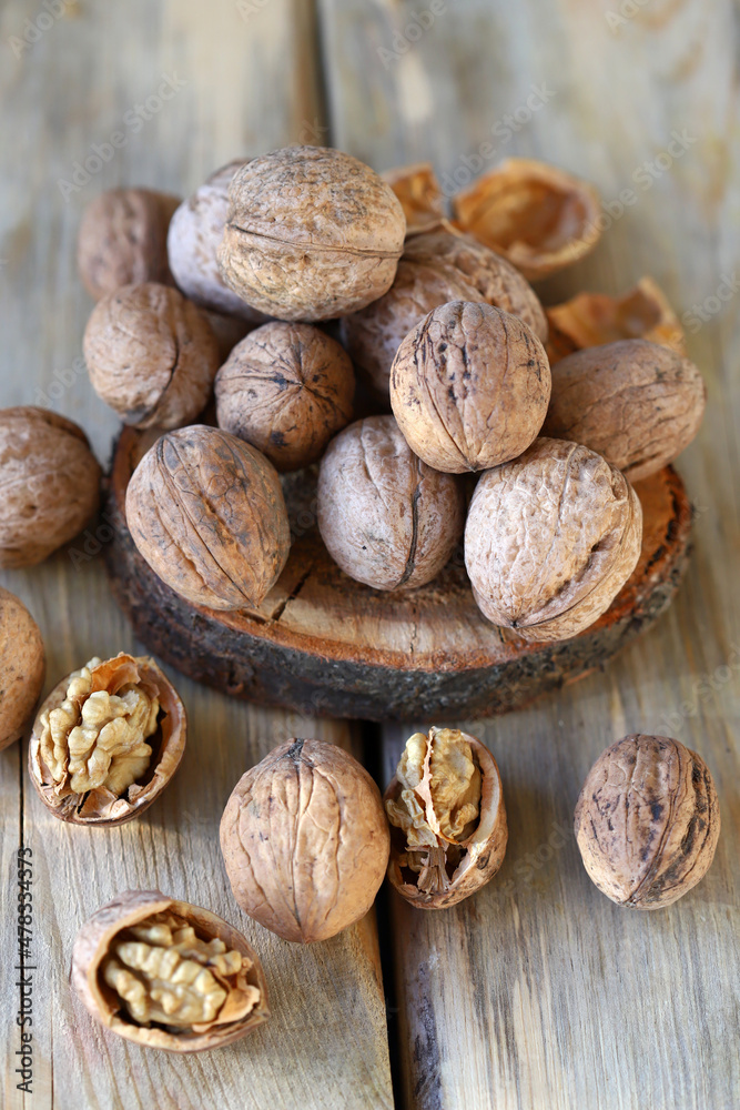 Walnuts in shells on a wooden surface. Walnuts in shells on a wooden surface.