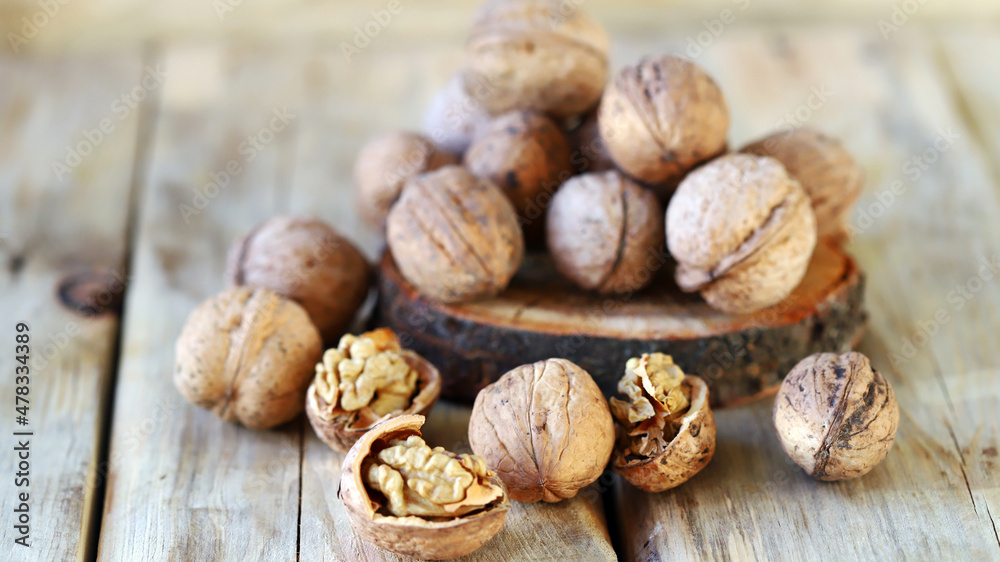 Walnuts in shells on a wooden surface. Walnuts in shells on a wooden surface.