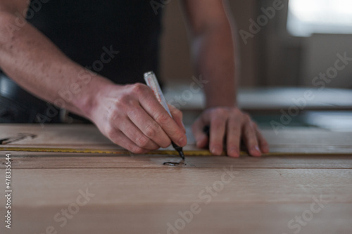 Marking something on a piece of wood. © Timo