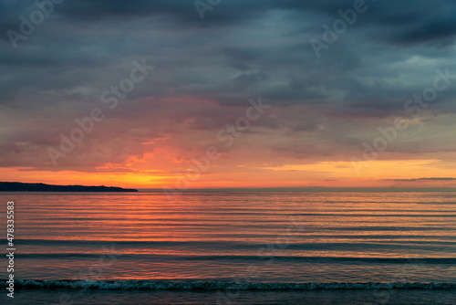 beautiful fiery sunrise on the beach - space for text