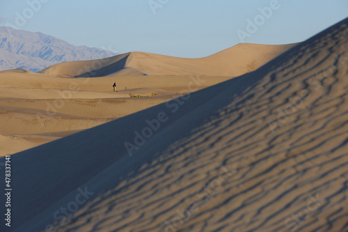 Photographer pondering shooting the sand dunes at Mesquite Flat  Death Valley National Park  California