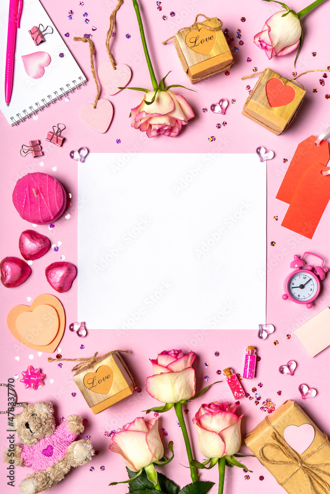 Happy Valentine's day. Roses flowers, hearts, gifts and decorative items in pink pastel colors on pink background. Blank empty white paper sheet. Valentines day concept. Flat lay, top view, copy space